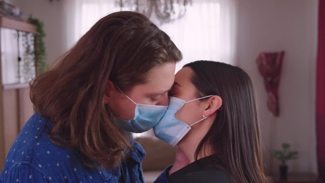Couple making out with disposable masks on - slow motion