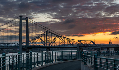 Carquinez Bridge seen from the shoreline in Crocket, Ca. on a cloudy morning with a colorful sky