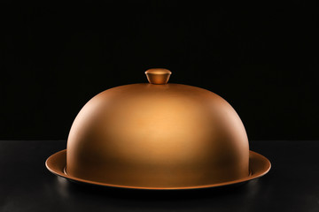 Tray and cloche on dark background