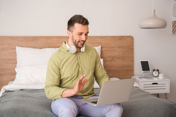 Young man video chatting at home