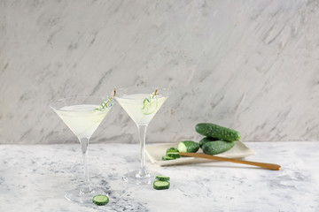 Glasses of tasty cucumber martini on table
