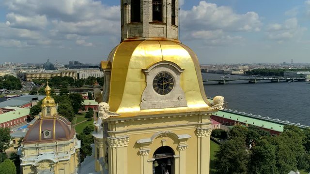 Flight around golden dome Peter Paul Petrograd Fortress Petersburg facade details. Close up watches stucco molding cupids. Old cathedral, tomb, Neva river. Famous tourist attraction. Central cityscape