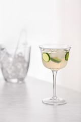 Glass of tasty cucumber martini on table