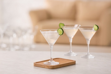 Glass of tasty cucumber martini on table