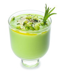 Glass with cold cucumber soup on white background