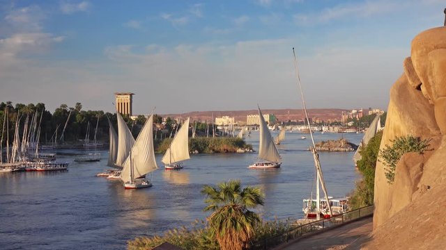 Beautiful landscape with felucca boats on Nile river in Aswan at sunset, Egypt, 4k