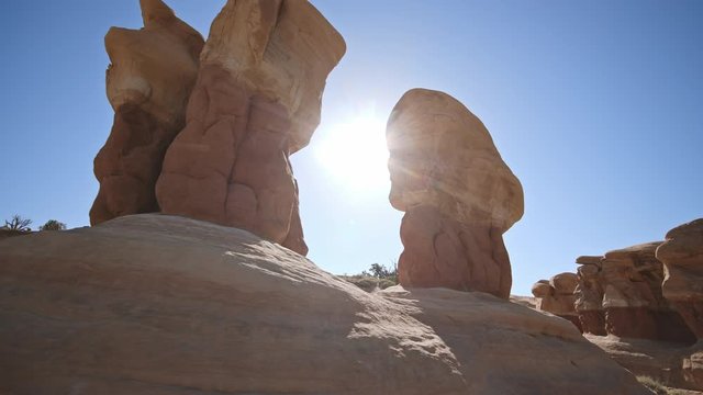 Hoodoos against the sky as the sun shines through in Escalante National Monument.