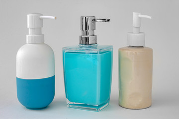 Colorful soap dispenser for bathrooms or kitchen sinks on a grey background