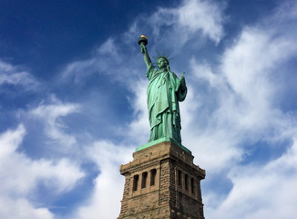 Fototapeta premium Statue of Liberty Against Dramatic Blue Sky