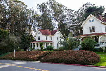 Historical military built building surrounded by tall eucalyptus trees. Presidio National Park, San Francisco