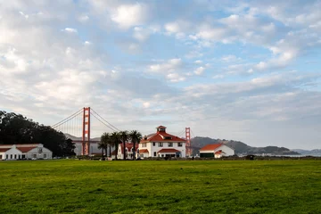 Fotobehang View to the Golden Gate Bridge from Crissy Field Park. White houses with red roof © auseklis