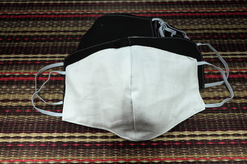 Naklejka premium Pile of face mask made from cloth for protection Corona virus. Handmade cloth mask. Self-protection for avoid virus infection.