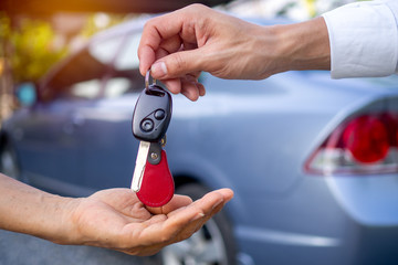 Sales agencies are selling cars and giving keys to new owners. sell car or rental car