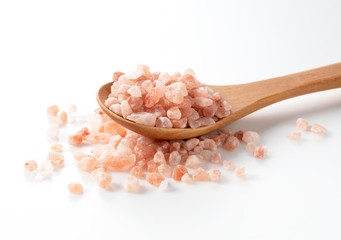 Fototapeta na wymiar Pink rock salt in a wooden spoon placed on a white background