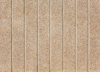 Fototapeta premium Pebbles Small stones on concrete wall.