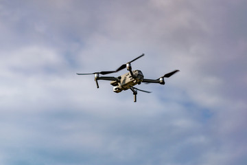 Fototapeta na wymiar Drone with professional camera flying in the blue sky