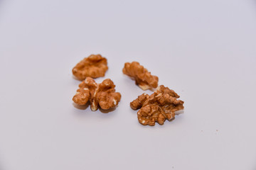 group peeled walnut on a white kitchen table