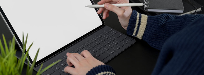 Cropped shot of female freelancer working on mock-up digital tablet