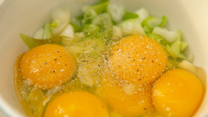 Eggs, spring onion and seasoning in bowl