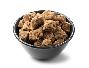 Shooting a block of brown sugar in a black container placed on a white background from an angle
