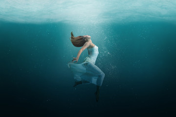 Dancer underwater in a state of peaceful levitation as she dances. 