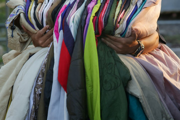 Huge selection of different used clothes for men, women and children on the rack in a second hand...