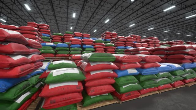 Bags In Warehouse, Large Stack Of Building Materials Bags Stored In Construction Depot. Colorful Bags Full Of Concrete And Cement Stacked In Storehouse. Seamless Loop Animation.