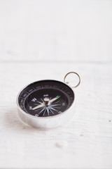 Compass On White Wooden Table