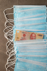 Vietnamese currency with face mask