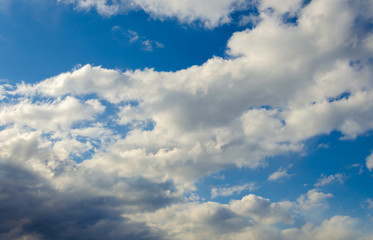 White clouds in the afternoon on a Sunny day against a blue sky.