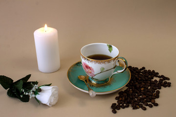 .coffee, flowers, candles on a beige background as a symbol of home warmth and coziness