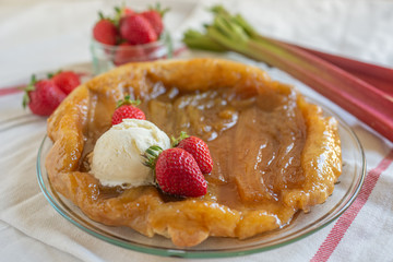 Rhubarb upside down cake with strawberries and ice cream