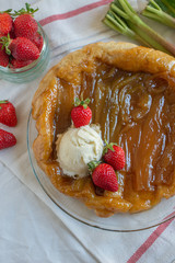 Rhubarb upside down cake with strawberries and ice cream