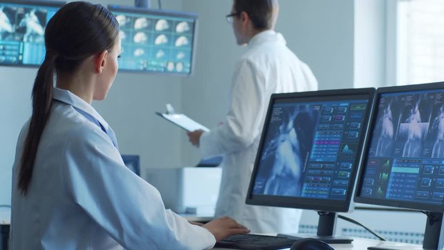 Medical doctors working in hospital office making computer research. Medicine, healthcare and technology concept.
