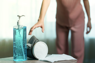Respirator masks and hand sanitizer gel, woman hand choosing respirator masks  for Coronavirus corona virus prevention (PPE)