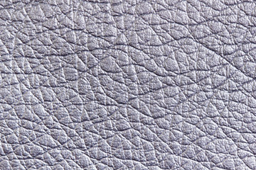 Background from a sample of furniture leather crumpled structure of silver color in macro. Furniture fabric.