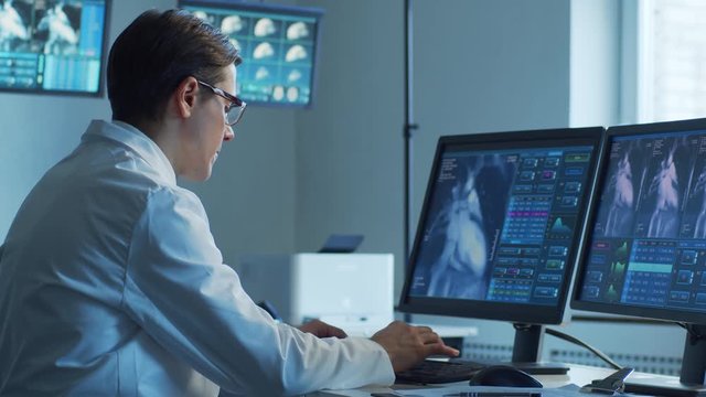 Medical doctors working in hospital office making computer research. Medicine, healthcare and technology concept.
