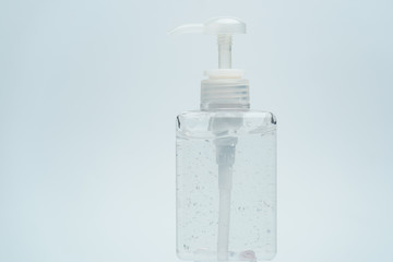 Clear hand sanitizer in a clear pump bottle on a white background.