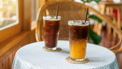 Iced americano coffee and orange juice in a cafe.