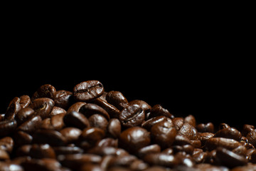 Roasted Coffee Beans texture on dark background, macro.