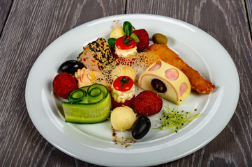 food platter with meat rolls and meatballs with cheese and meat and vegetables with sauces