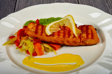 lunch or dinner with a plate of fish and vegetables and lemon and delicious sauces