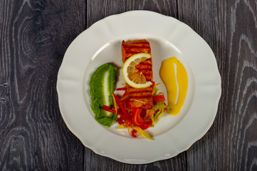 lunch or dinner with a plate of fish and vegetables and lemon and delicious sauces