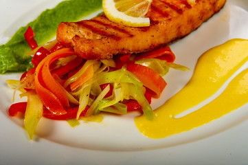 lunch or dinner with a plate of fish and vegetables and lemon and delicious sauces