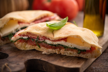 Sandwich from arab bread with lettuce rucola, slices of fresh tomatoes,cheese and ham.