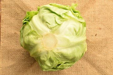 Fresh green cabbage on jute cloth.
