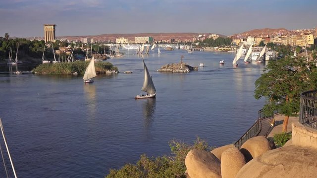 Beautiful landscape with felucca boats on Nile river in Aswan at sunset, Egypt, 4k