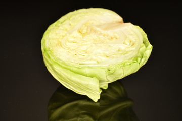 Fototapeta premium Green cabbage, macro, on a black background