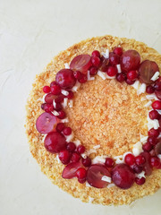 Napoleon cake with berries close-up on a light background top view.