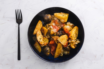 plant-based food, vegan veggie roast with potatoes apples brussel sprouts and tomatoes